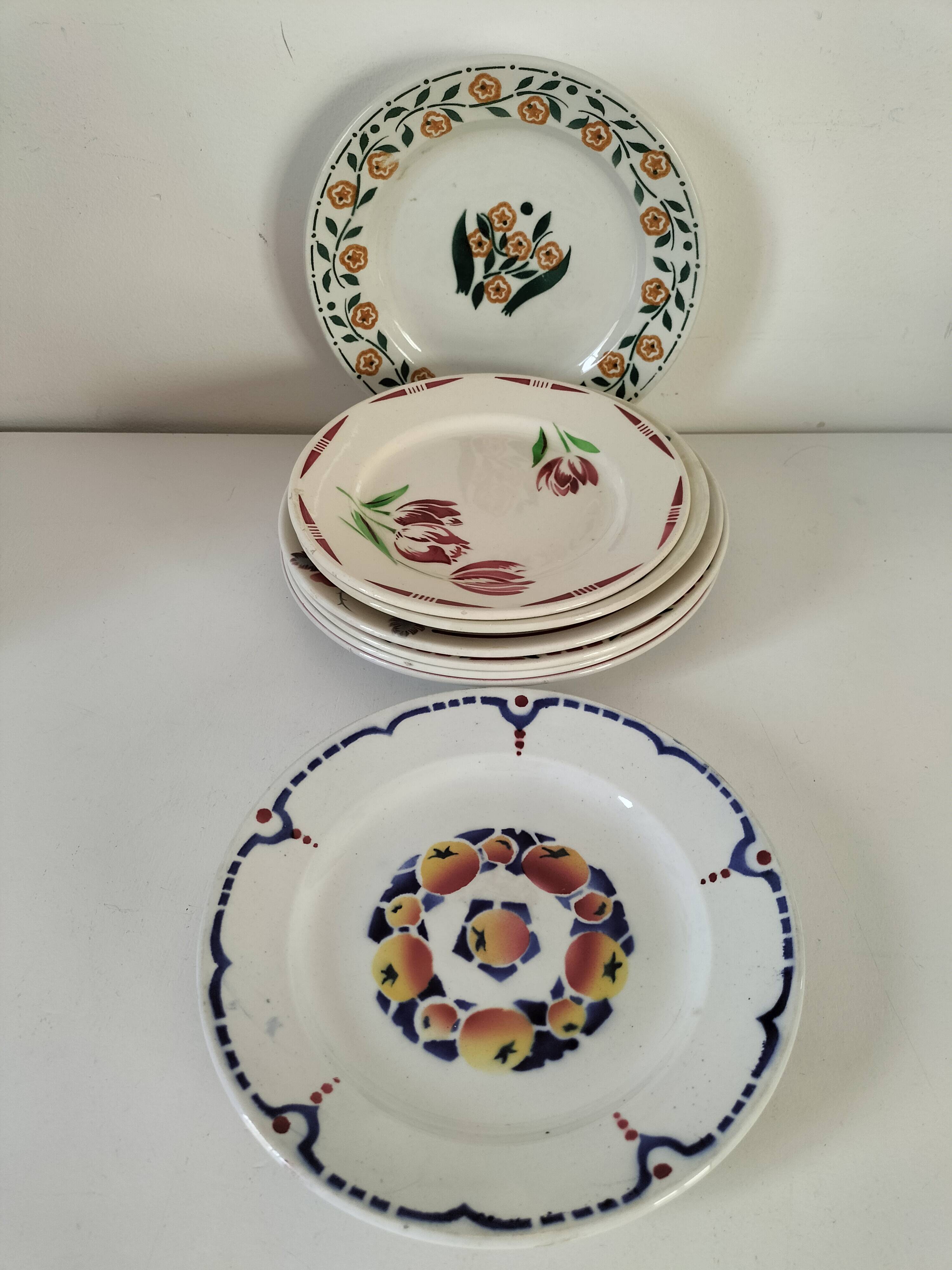 Set of 8 ironstone plates with coordinated designs.