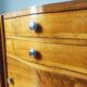 Pair of Art Deco curved bedside tables in light wood.