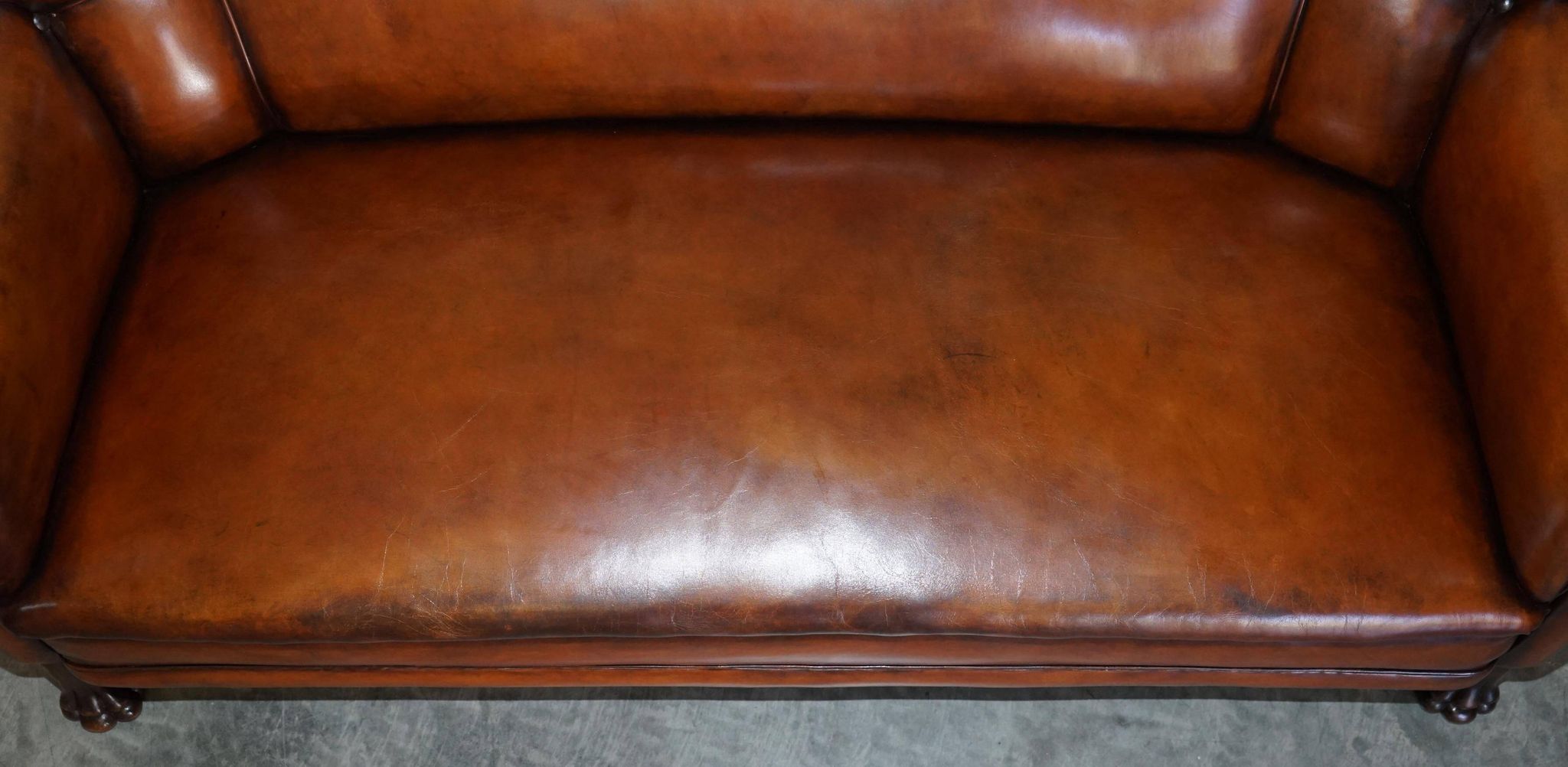 Victorian Chesterfield leather canapé with oak lion claw feet.
