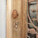 Front door of a house or building in the city centre, with a dolphin door knocker and frame + transom.