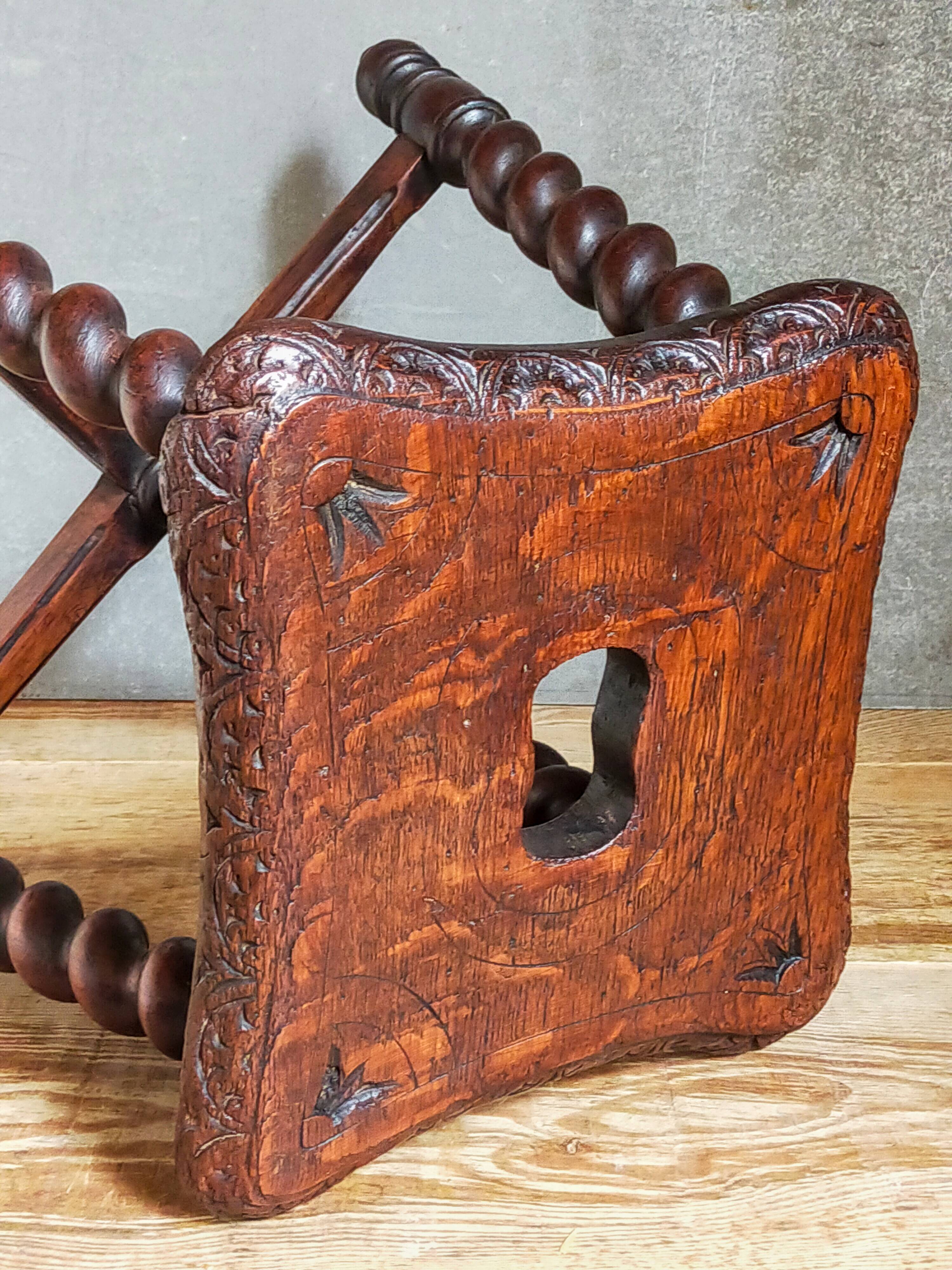 Antique stool in turned and carved solid wood