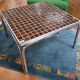 Vintage square coffee table with chrome legs and small tiled squares.