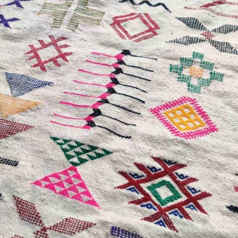 White Moroccan rug with Berber patterns.