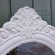 Oval mirror with white frame