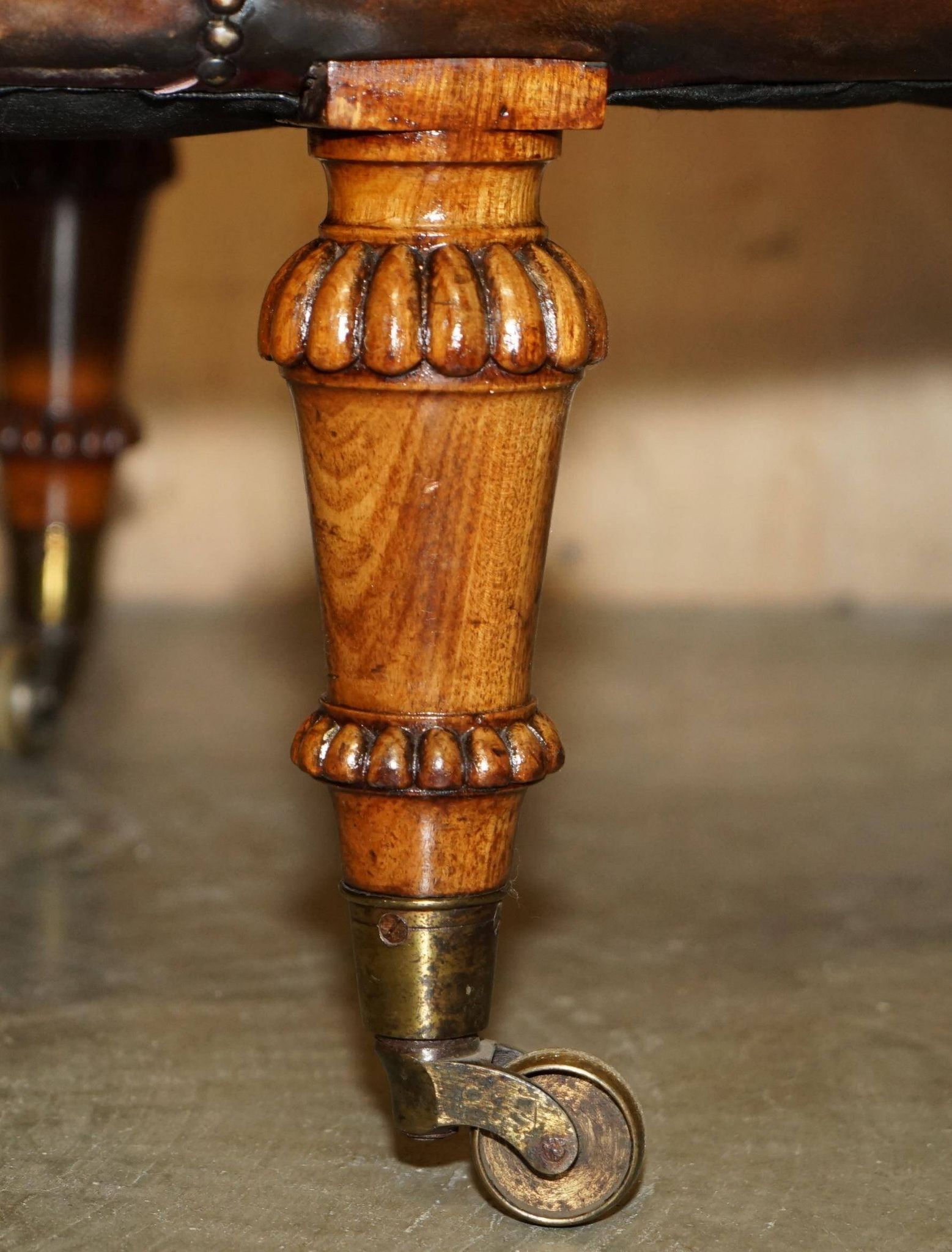 High Victorian leather tête-à-tête canapé with a walnut burr chessboard.