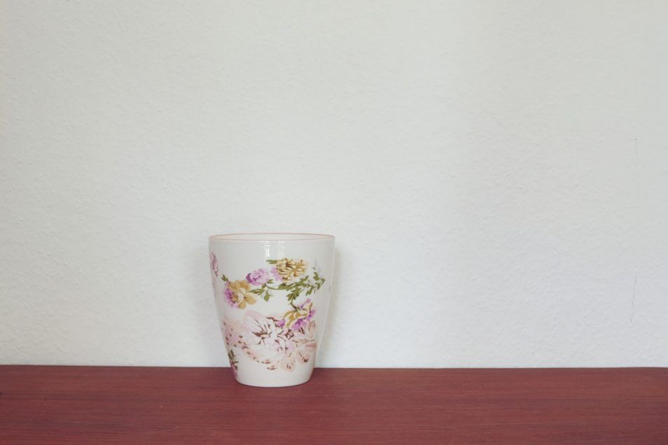 Vintage beige high flowerpot with flowers