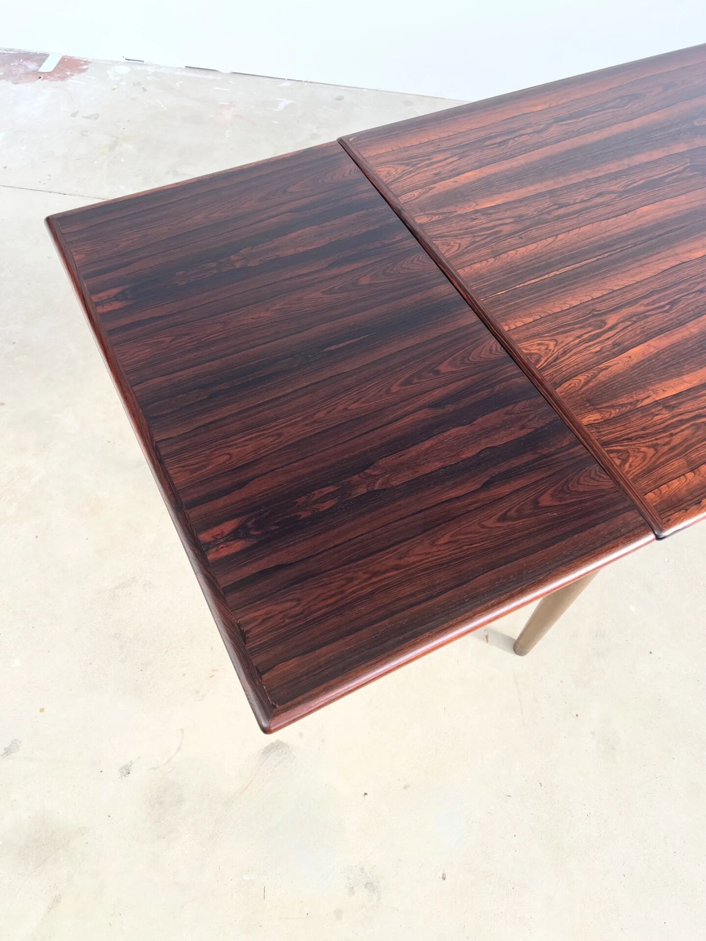 Rosewood dining table with integrated extensions — Denmark, 1960s