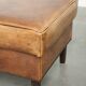 Cowhide ottoman with a beautiful patina finished with decorative nails