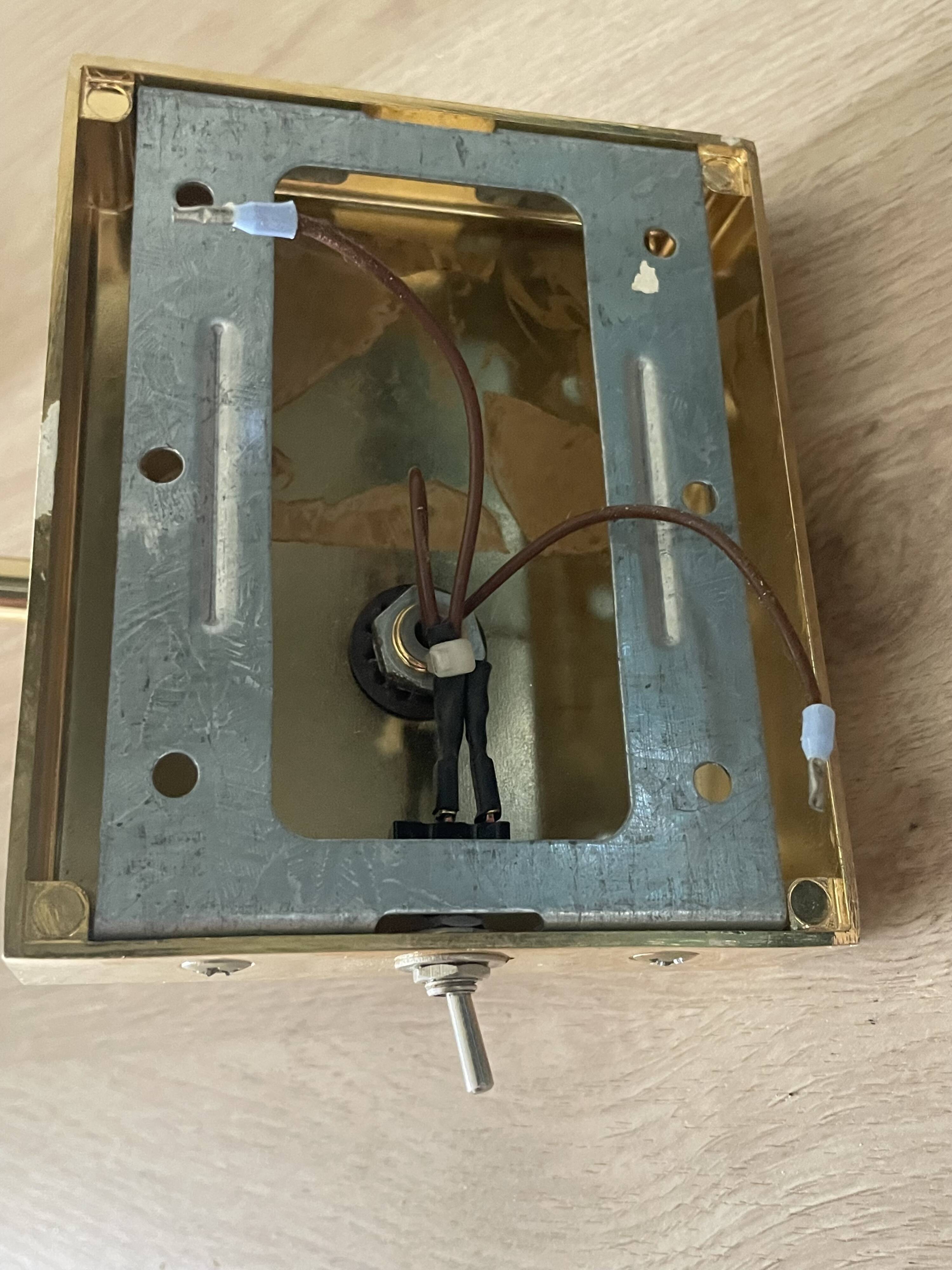 Pair of vintage brass wall lights with adjustable arms.