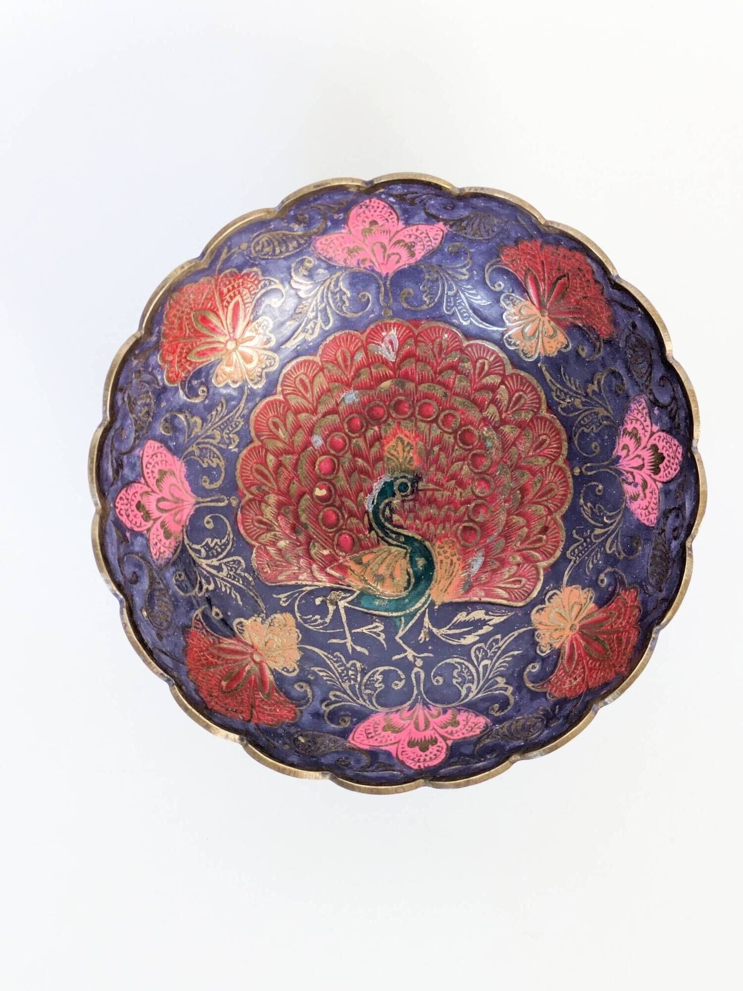 Vintage brass bowl with peacock motif, painted enamel, scalloped edge on a pedestal.