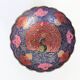 Vintage brass bowl with peacock motif, painted enamel, scalloped edge on a pedestal.