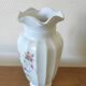 Porcelain vase with floral decoration and gold trim.