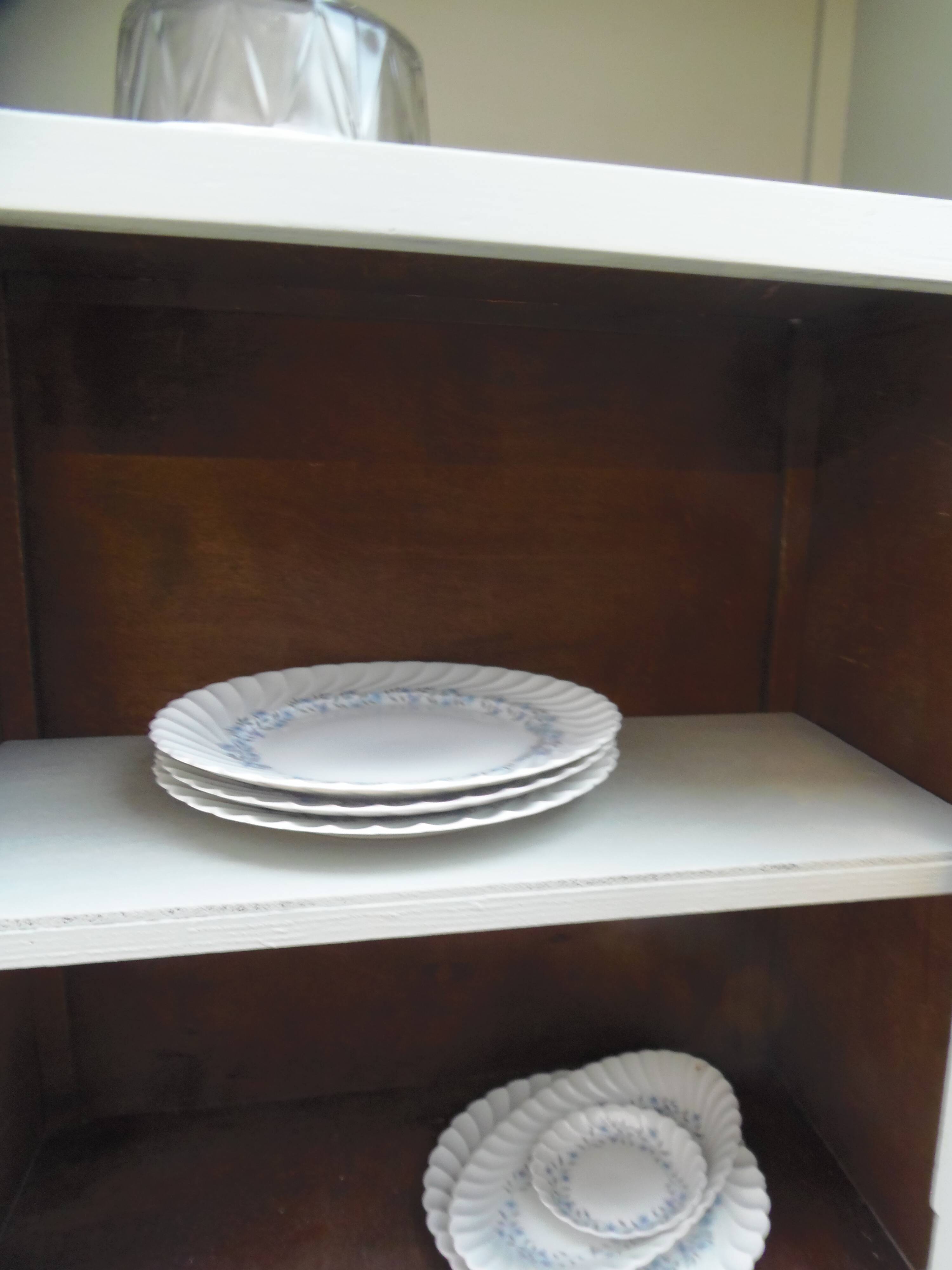 Vintage furniture of shallow depth re-enchanted in grey-green.