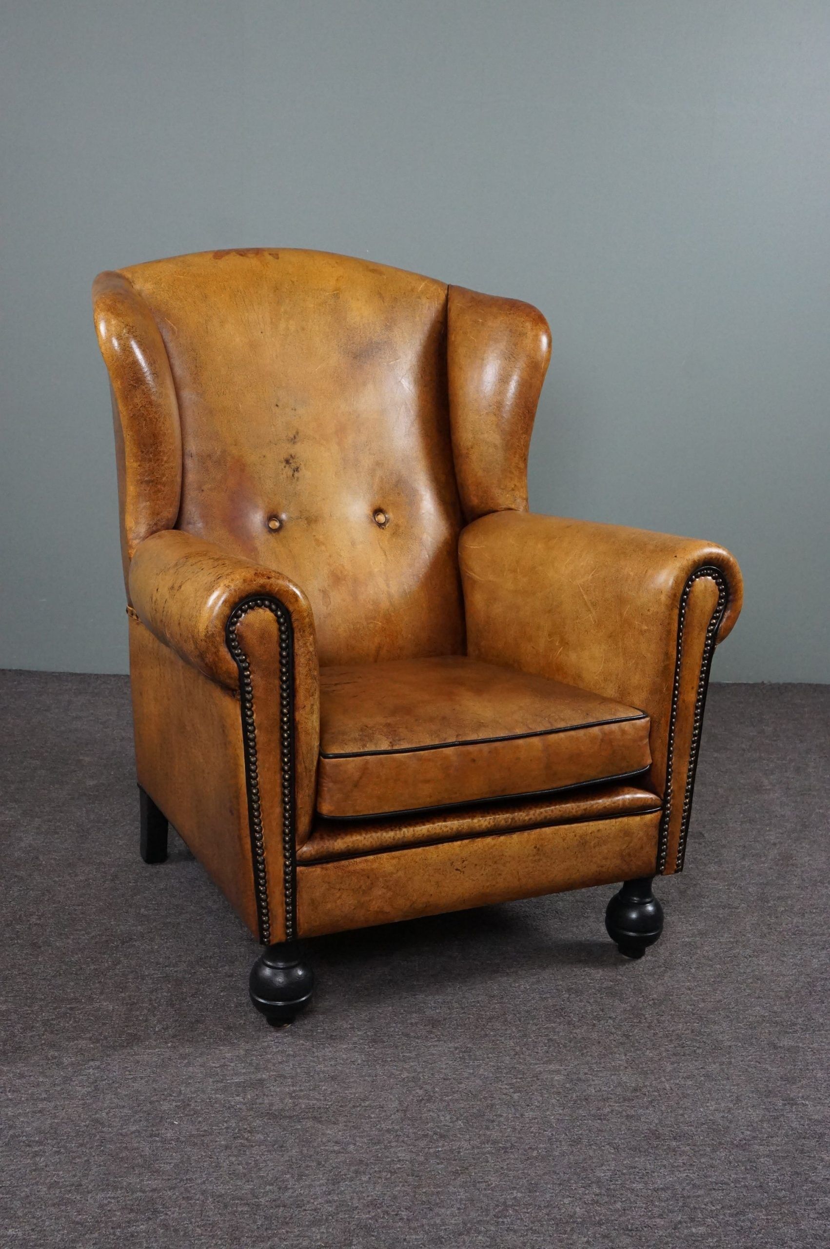 Antique armchair in patinated sheepskin