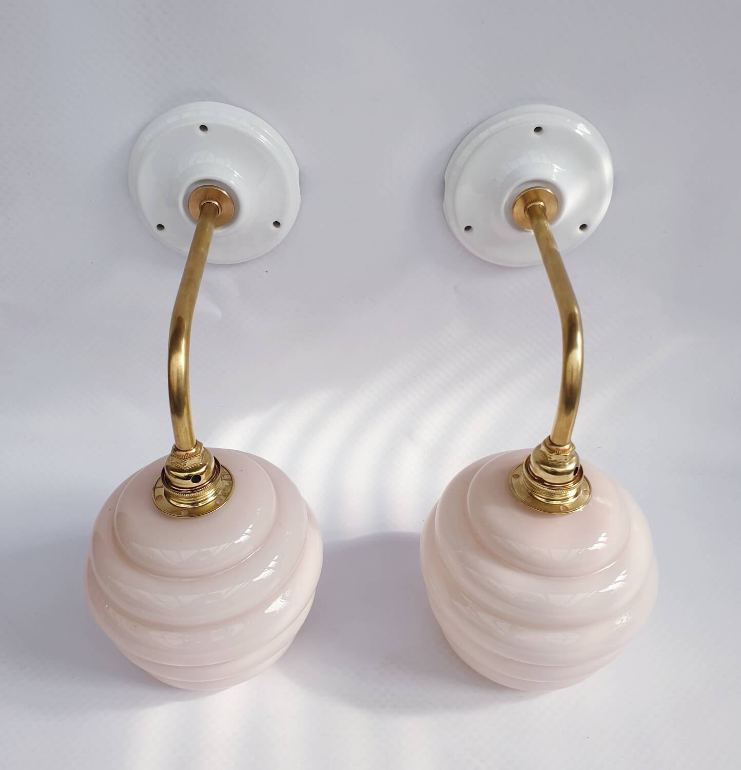 Swan neck and glass globe wall lights