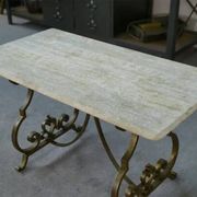 Side table with a gilt wrought iron base attributed to Gilbert Poillerat, with a travertine top, 1940s