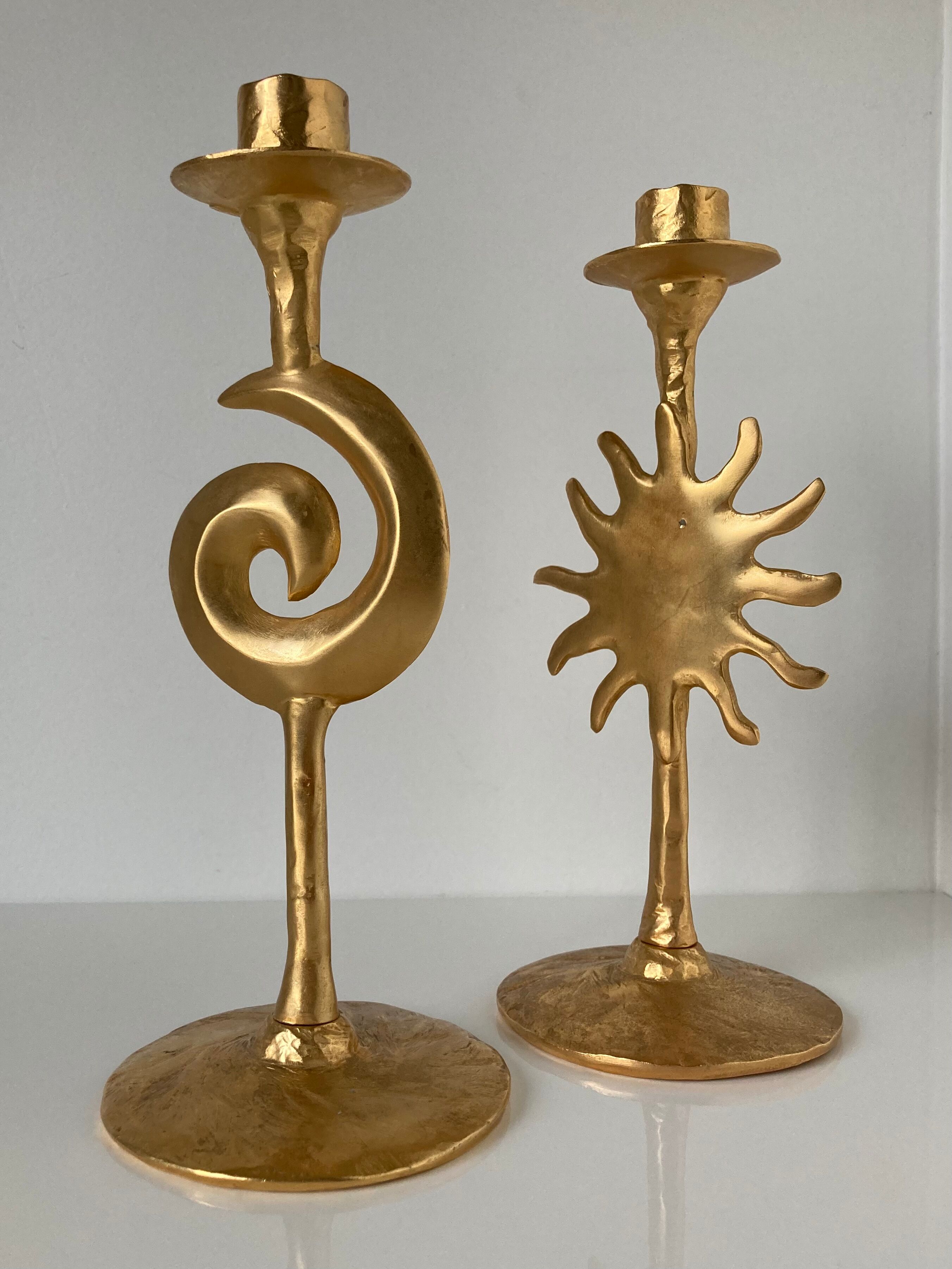 Paire de bougeoirs lune et soleil en métal doré par Édouard Rambaud