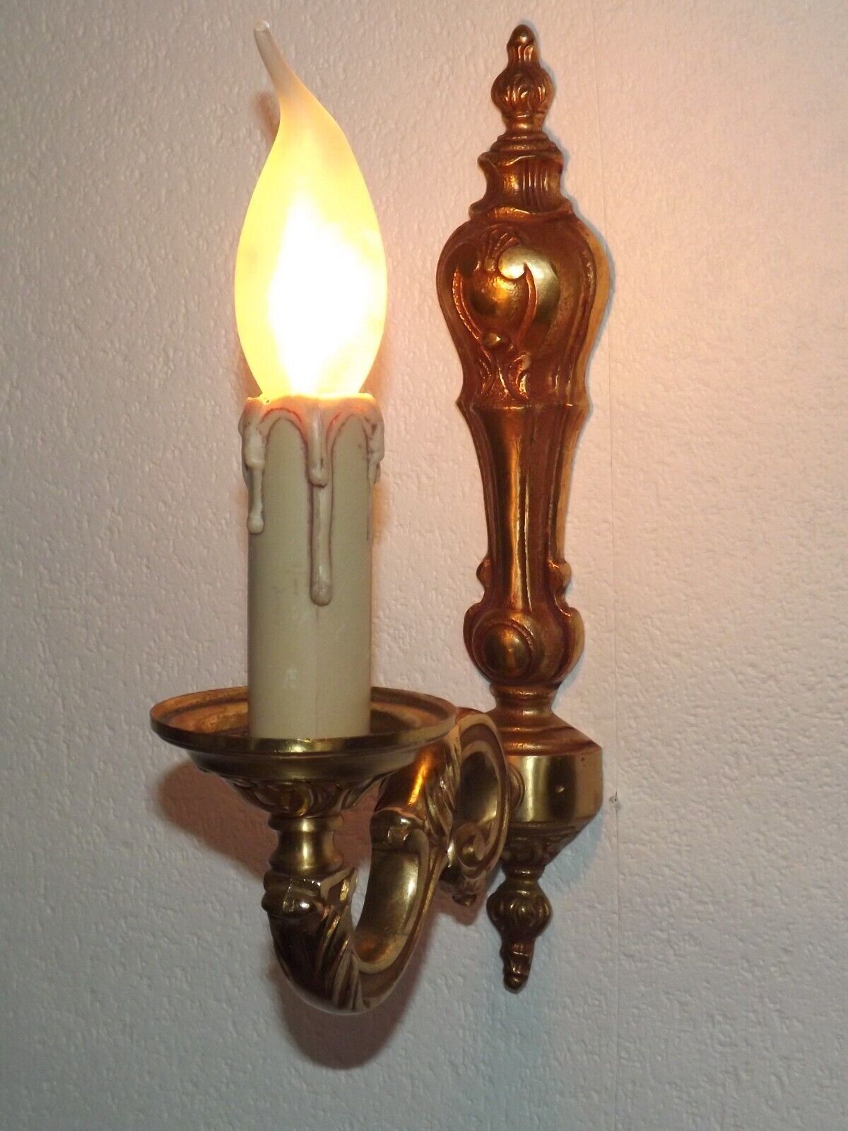 Simple wall sconce in classic Empire style in vintage French bronze.