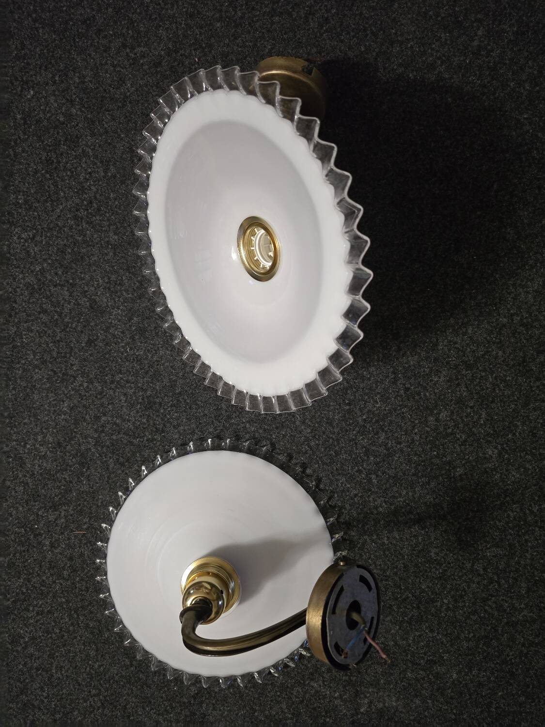 Wall sconces with scalloped opaline lampshades.