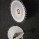 Wall sconces with scalloped opaline lampshades.