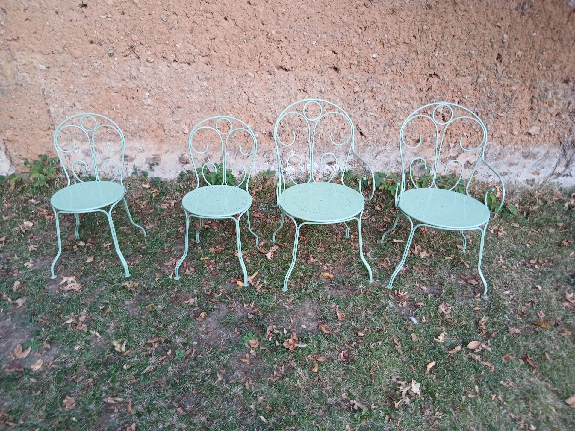 Garden furniture set with 1 table, 2 armchairs, and 2 chairs in antique green wrought iron.