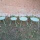 Garden furniture set with 1 table, 2 armchairs, and 2 chairs in antique green wrought iron.