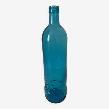 Blue glass bottle with embossed patterns at the bottom. Selters brand.