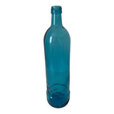 Blue glass bottle with embossed patterns at the bottom. Selters brand.