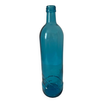 Blue glass bottle with embossed patterns at the bottom. Selters brand.