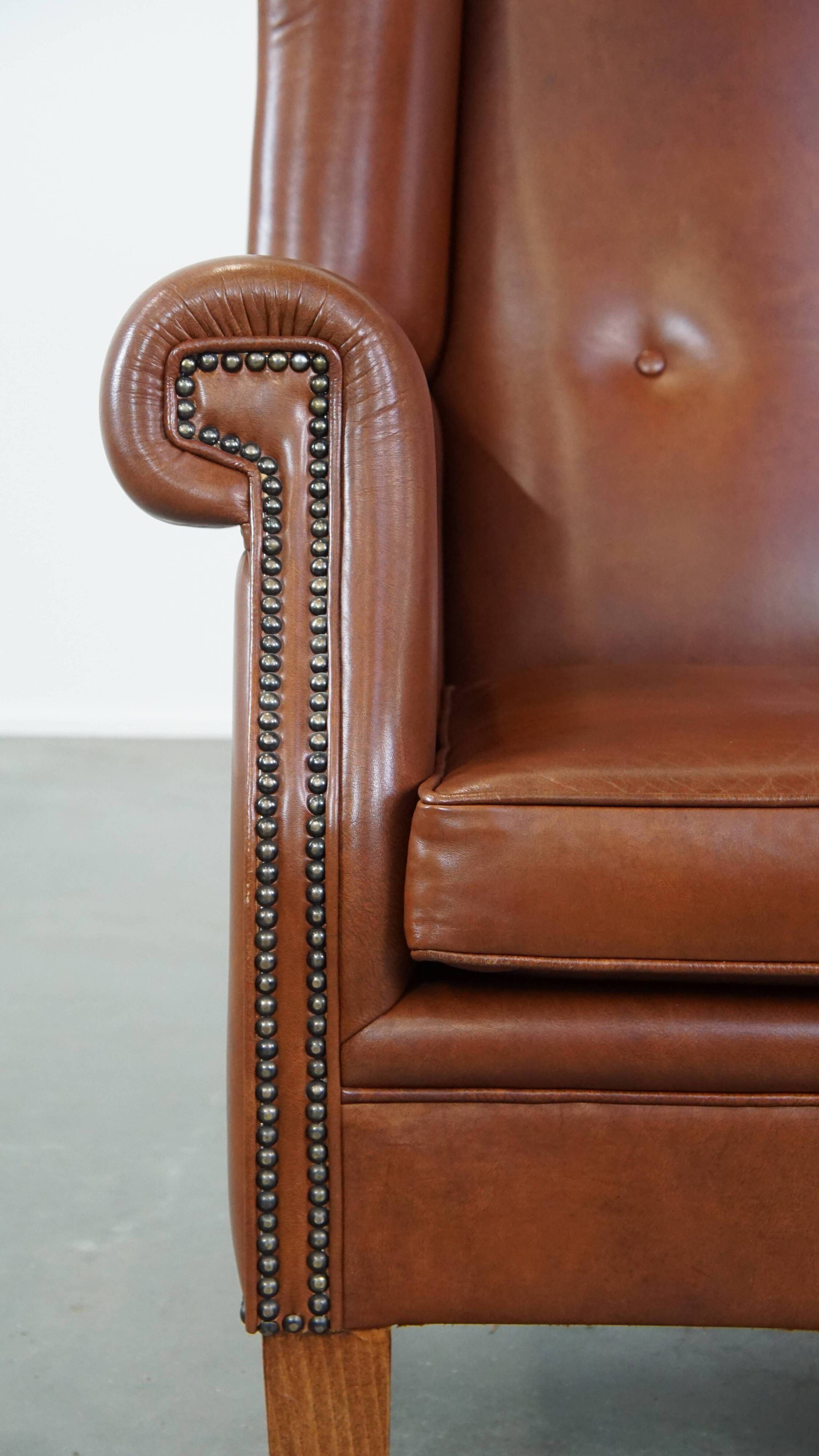 Cognac-colored leather wingback chair in English style