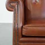 Cognac-colored leather wingback chair in English style