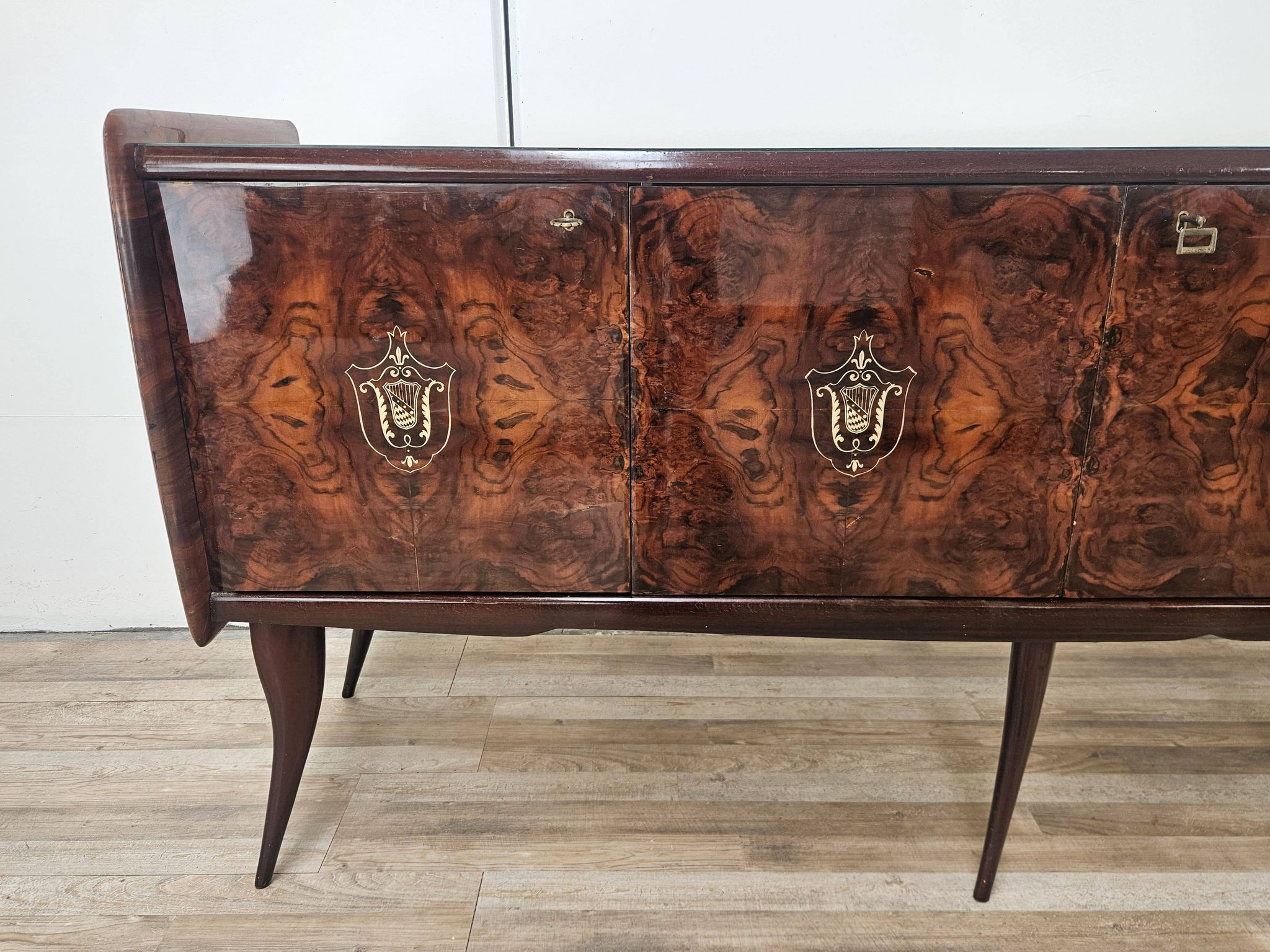 Mid-century mahogany buffet with teal glass and compartments with a drawer.