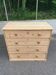 Victorian commode from the 19th century stripped to raw solid wood with ceramic knobs.