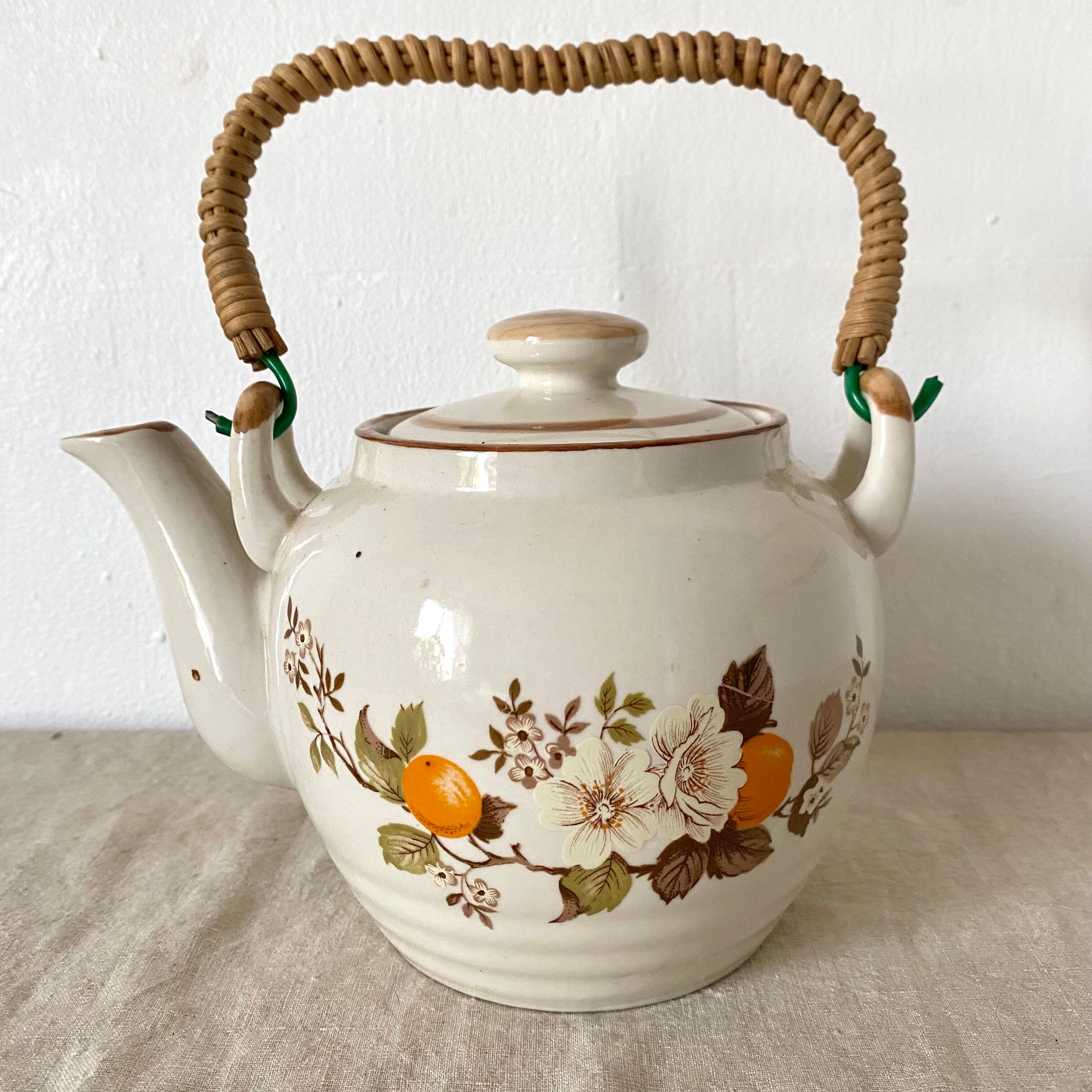Vintage porcelain and rattan teapot