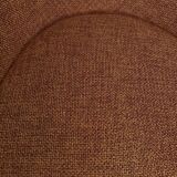 Circular armchair trimmed with orange fabric