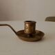 Antique hand-held candlestick in gilded bronze