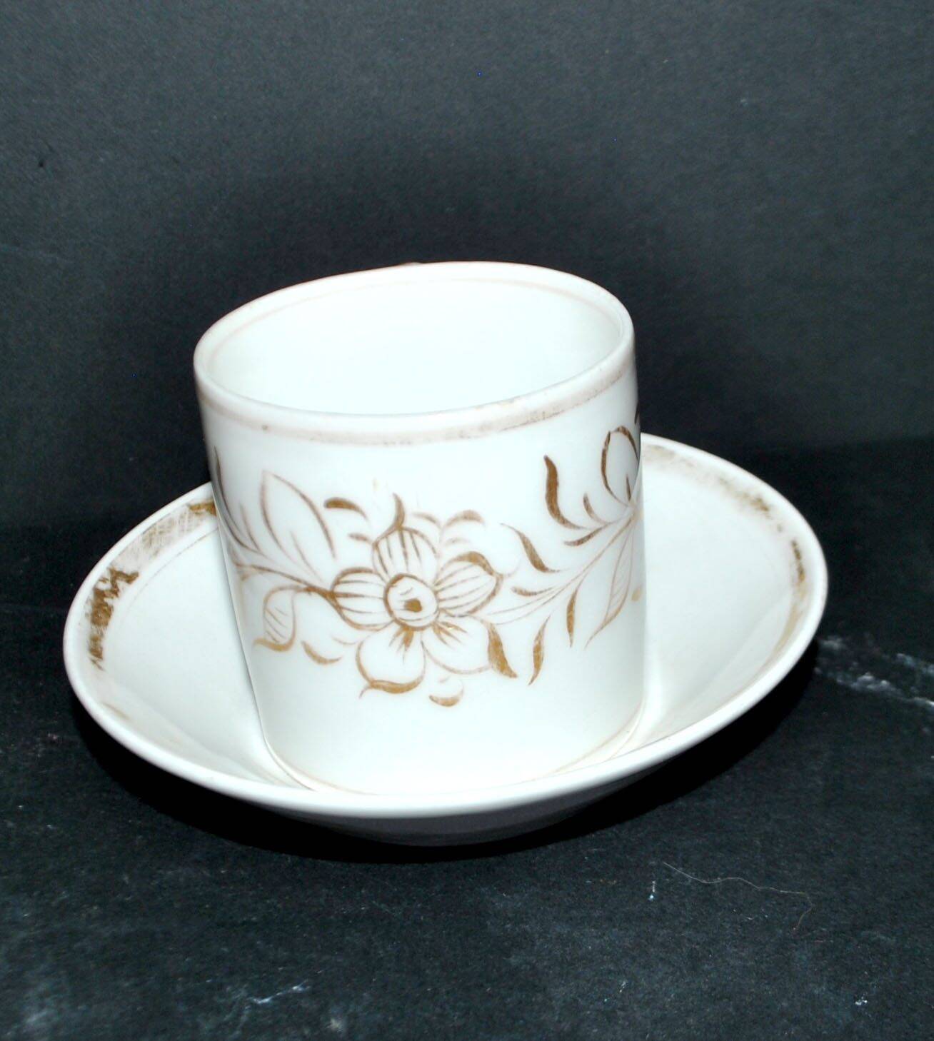 Paris porcelain coffee cup with floral design, antique porcelain with gold trim.