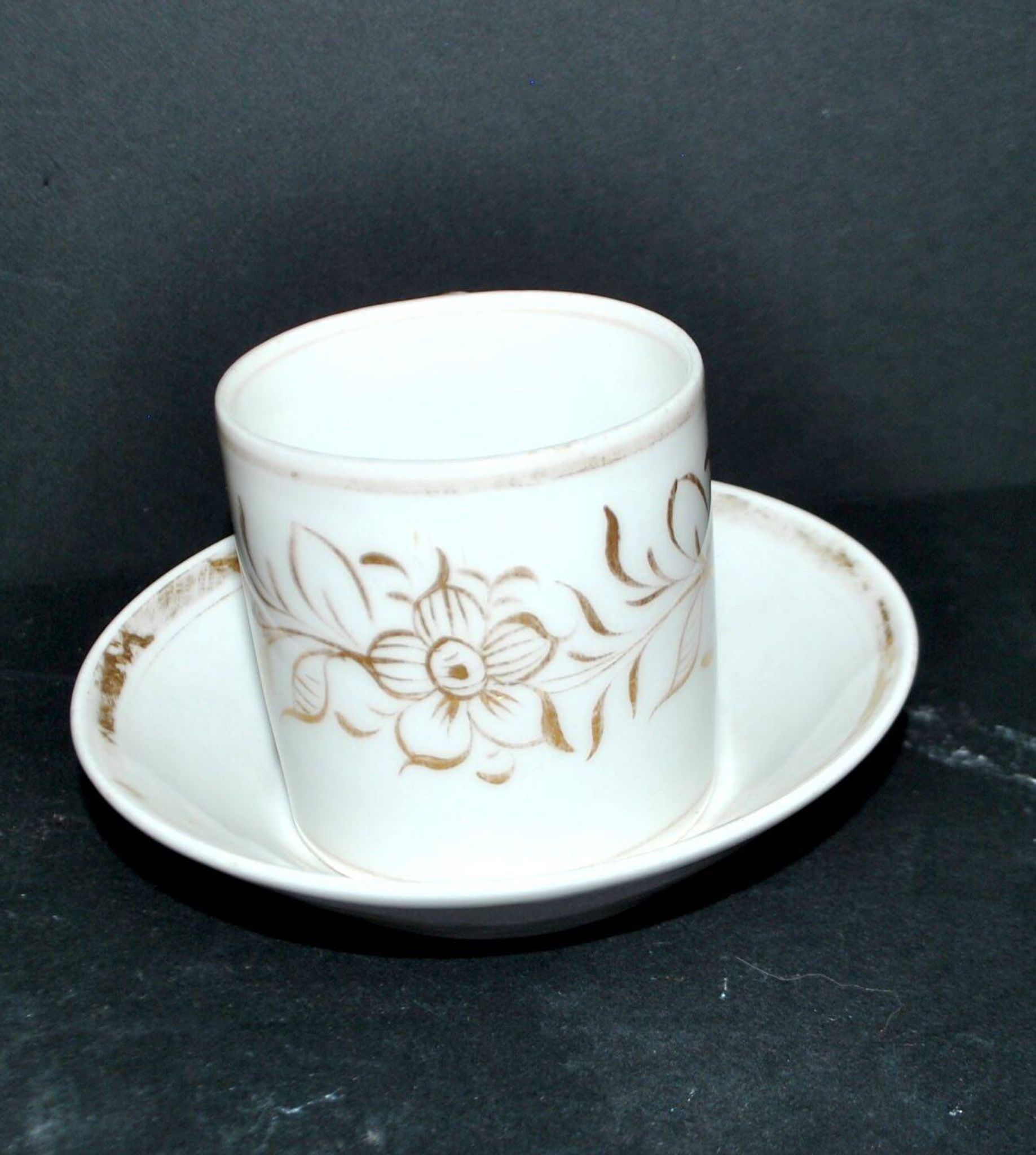Paris porcelain coffee cup with floral design, antique porcelain with gold trim.