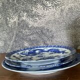 Asian porcelain plates decorated with blue dragons