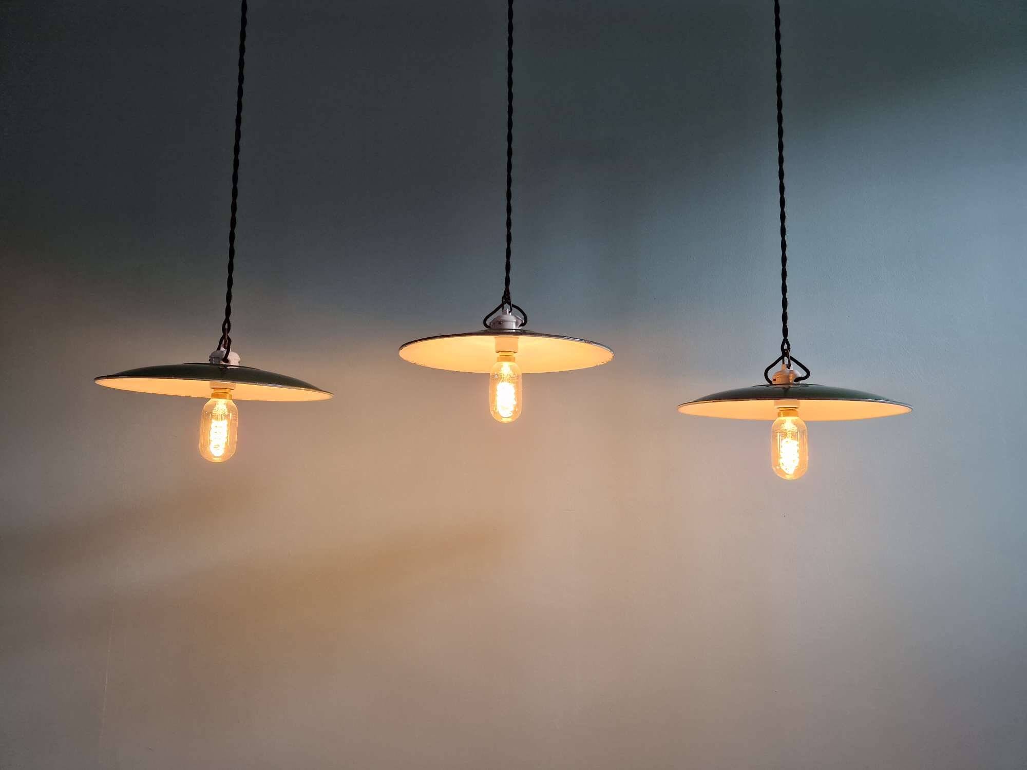 Trio of large industrial suspensions in green enamelled sheet metal.
