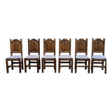 6 dining chairs in a country or farmhouse style, made of dark solid wood and rush-seated.