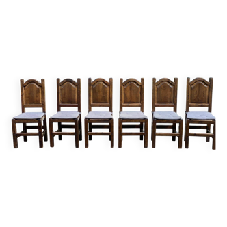 6 dining chairs in a country or farmhouse style, made of dark solid wood and rush-seated.