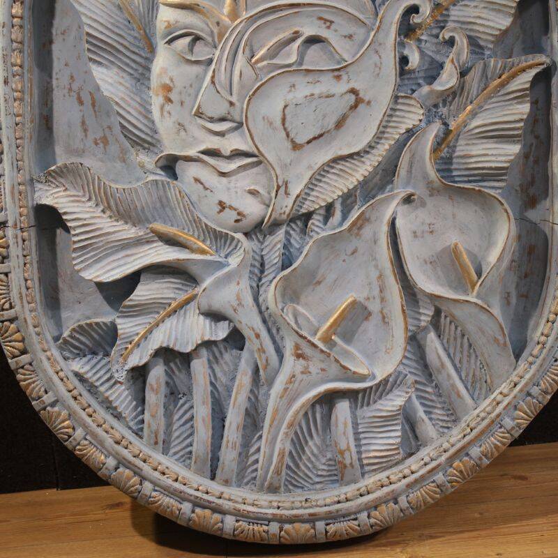Bas-relief sculpture, stylized face with flowers, 20th century