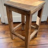 Brutalist stool in raw wood with a weathered effect.