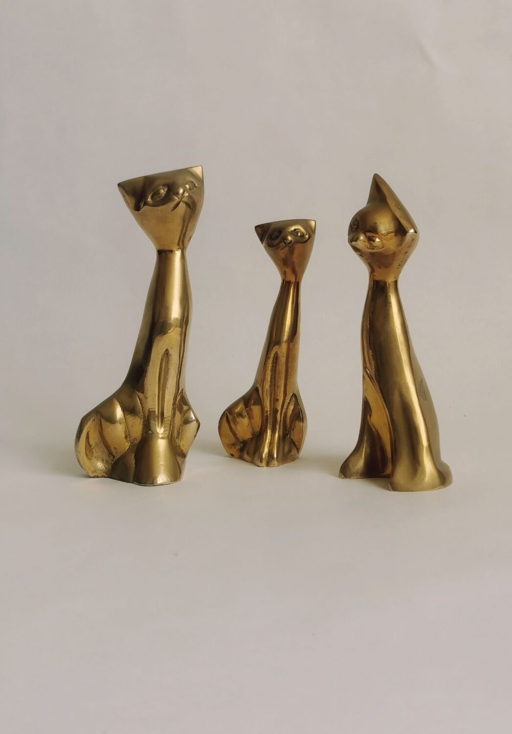 Trio of cats in gilded brass