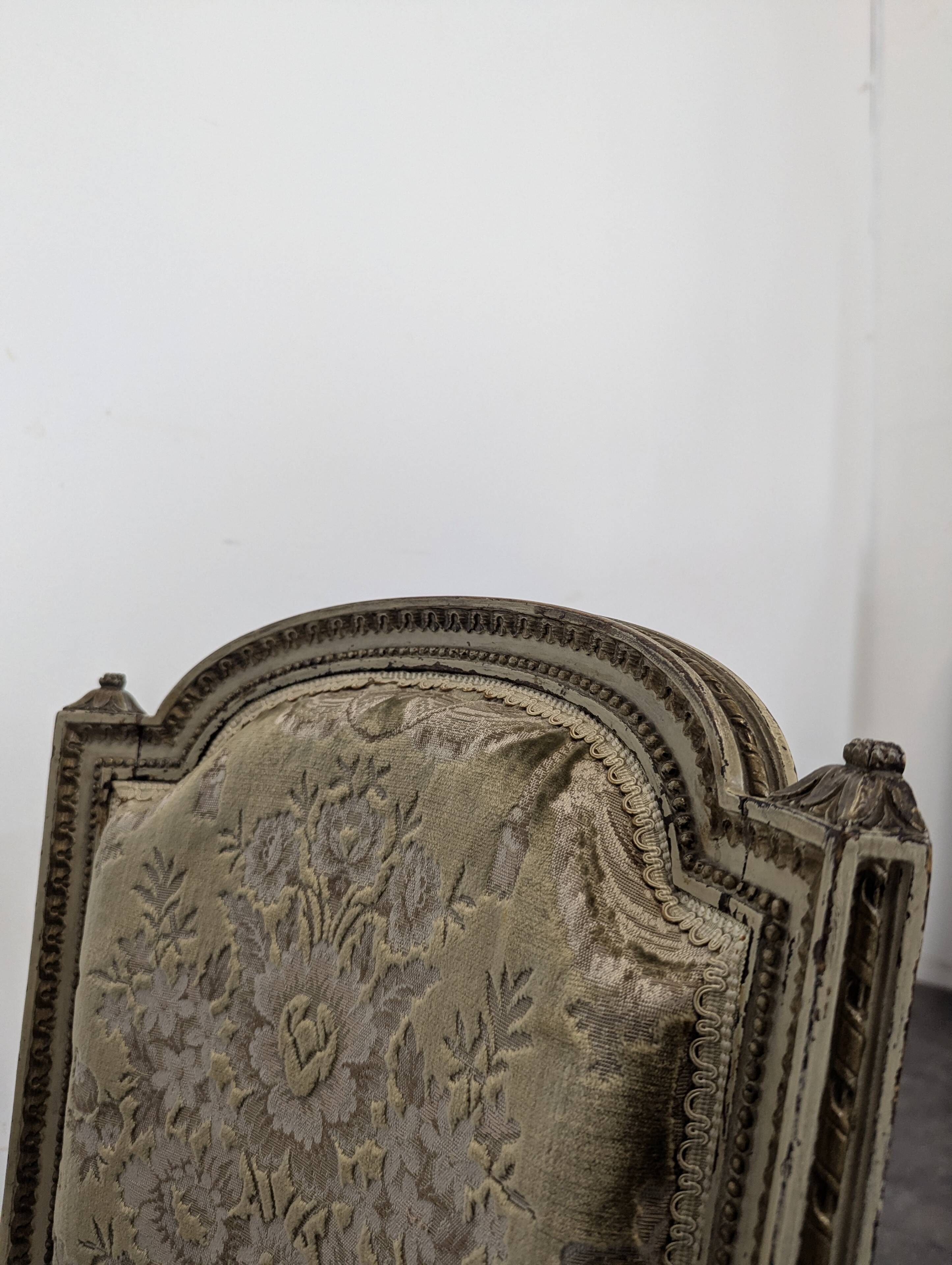 Cream lacquered Louis XVI style cabriolet salon with gold highlights.