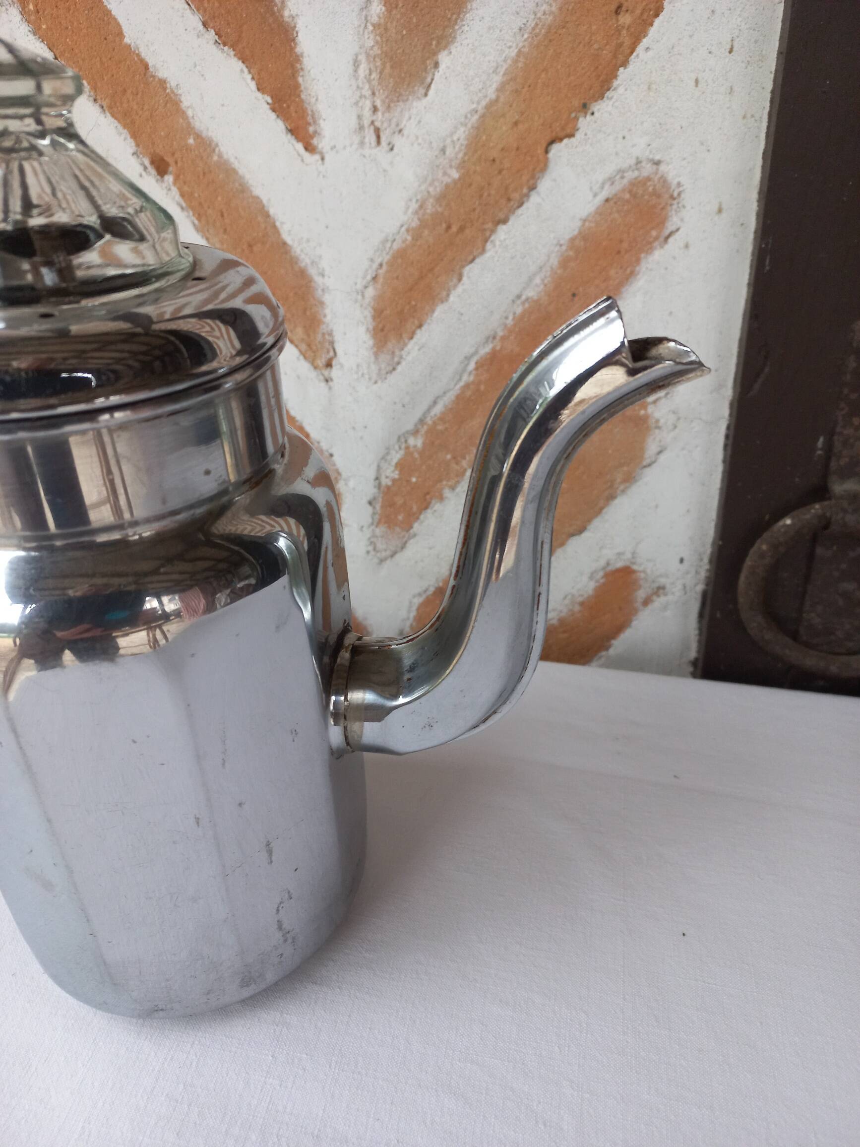Silver metal coffee maker with glass cap