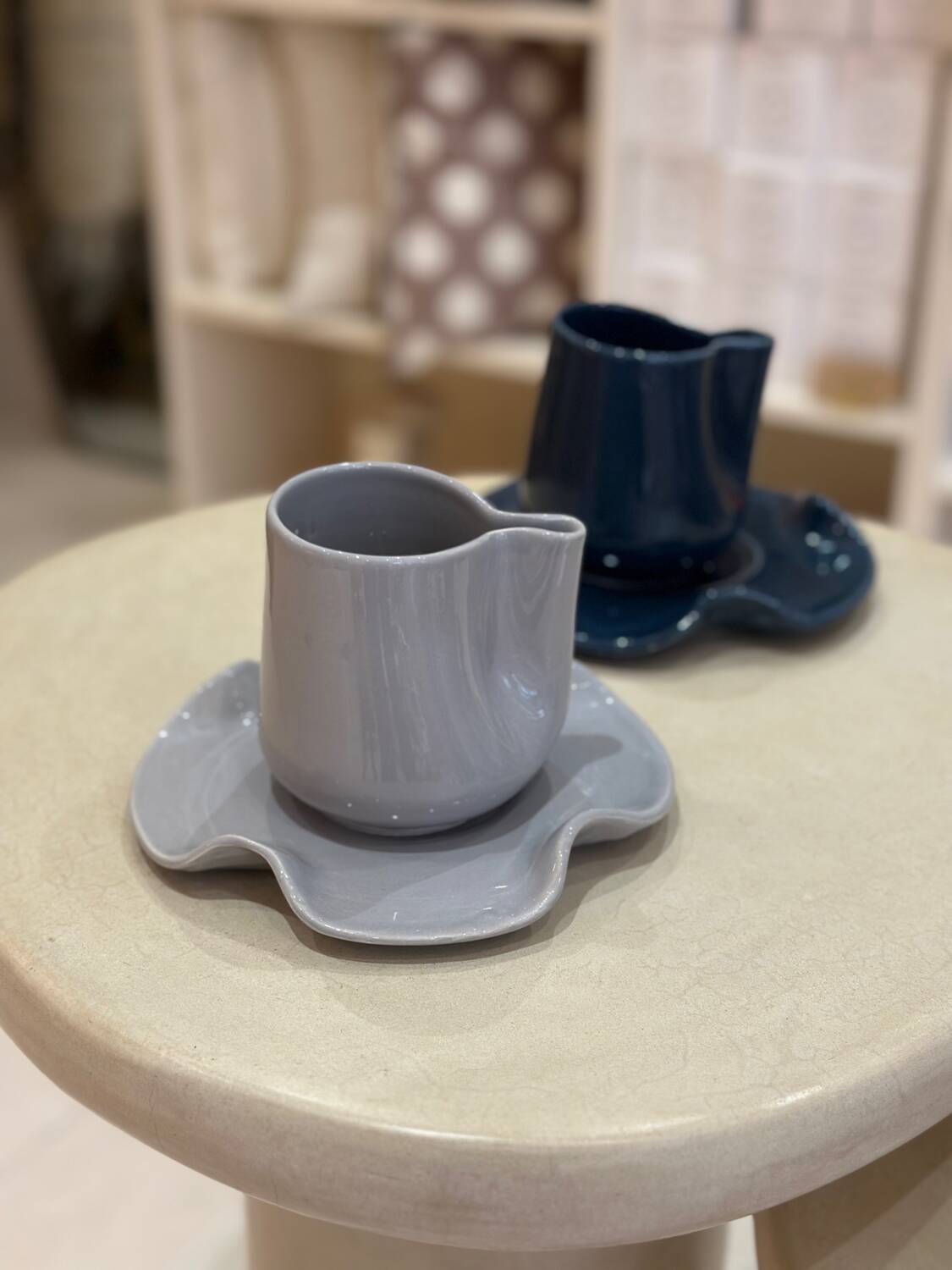 Set of ceramic artisan mugs with blue-grey pop water lily design.