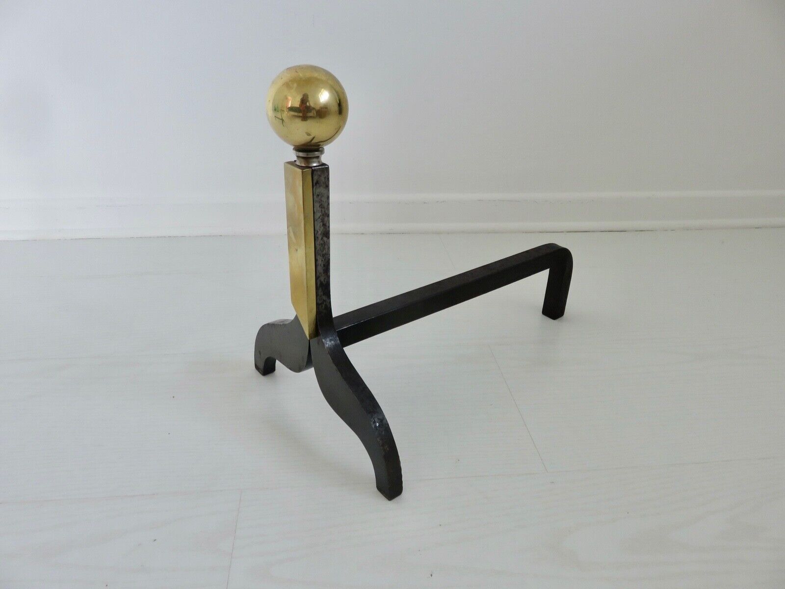 Pair of modernist steel and brass andirons