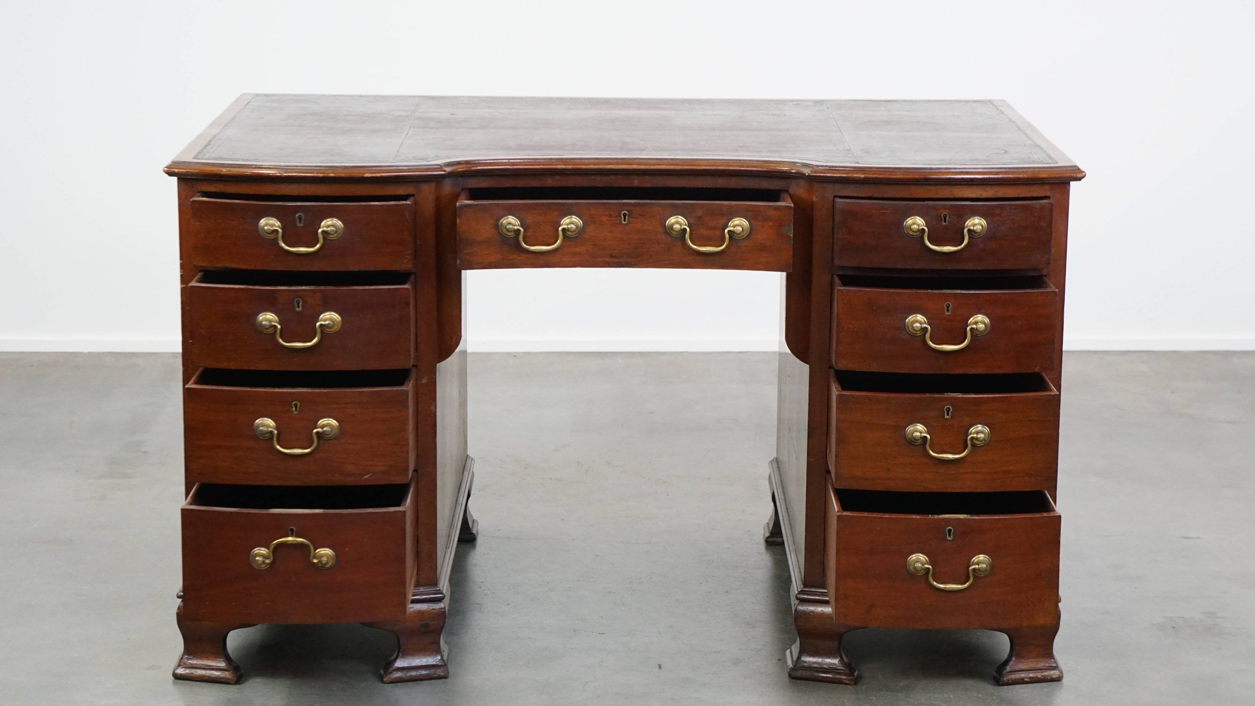 Antique English wooden desk from the late 19th century with a leather top